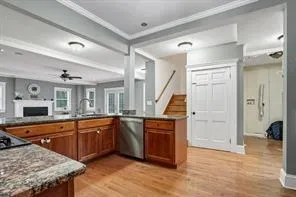 a large kitchen with stainless steel appliances granite countertop a sink and a stove