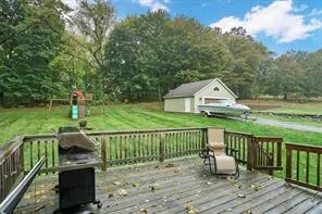 a view of a deck with two chair and wooden floor