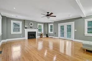 a view of a livingroom with furniture a fireplace and wooden floor