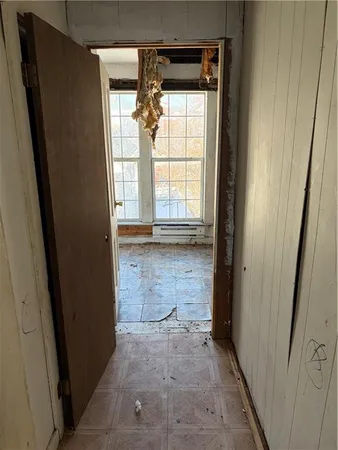 a view of an empty room with a mirror