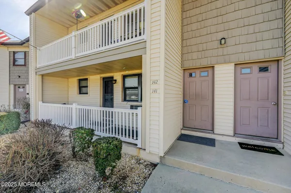 a view of a house with wooden fence