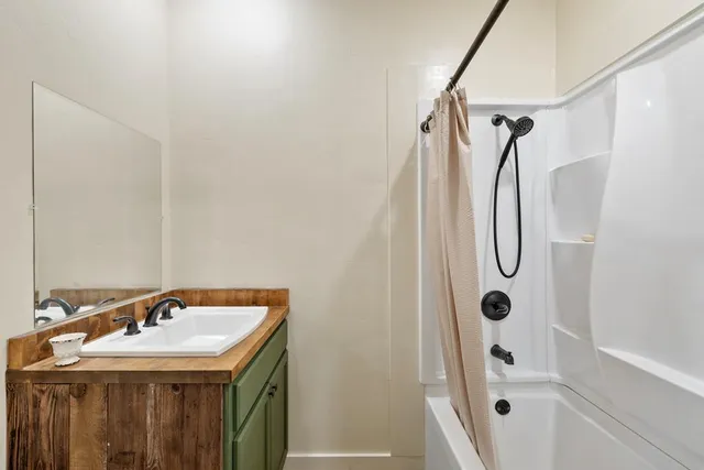 a bathroom with a sink and shower