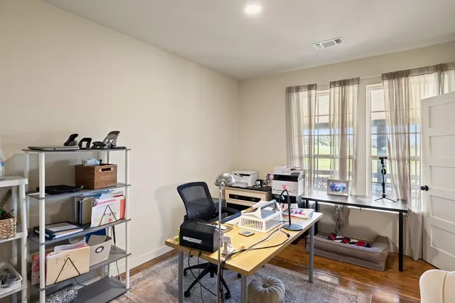 a living room with furniture a flat screen tv and a window