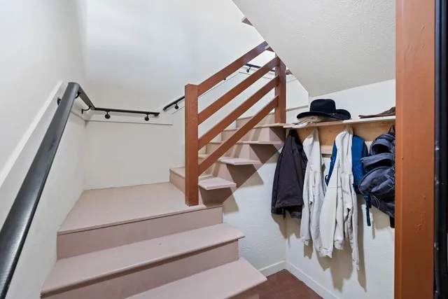 a bedroom with a large bed and a flat screen tv