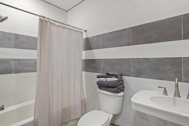 a view of a roof deck with wooden floor and fence