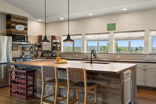 a kitchen with a table chairs sink and cabinets