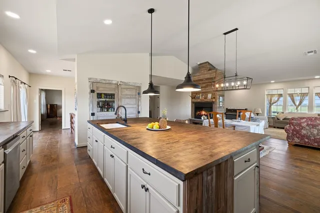 a view of kitchen island a sink and living room view