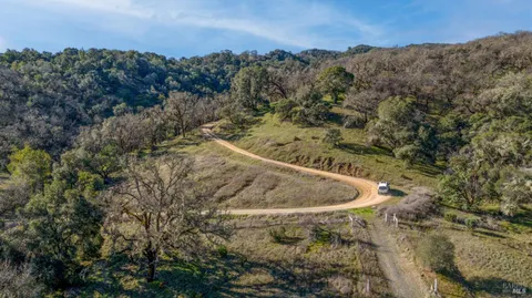 a view of a dry yard with mountains