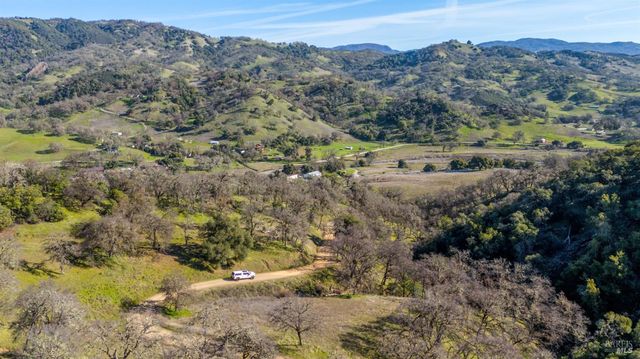 a view of a mountain with mountains in the background