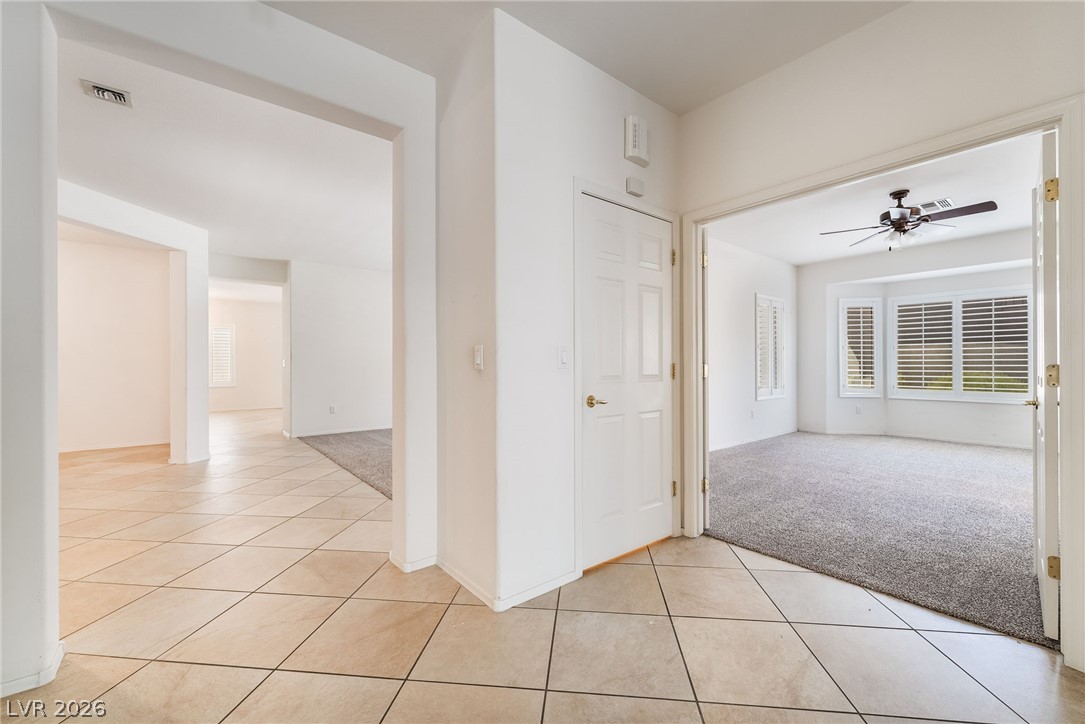 3033 Hartsville Road Henderson, NV 89052 - Photo 22 of 41 A versatile open-plan interior featuring a mix of durable tile and plush carpet flooring.