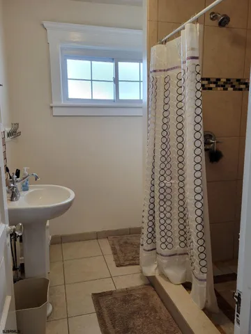 a bathroom with a shower toilet and a sink