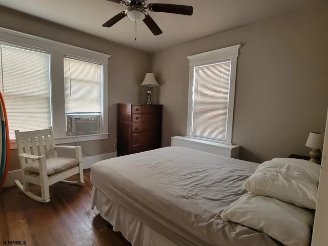 a bedroom with a bed and a chair