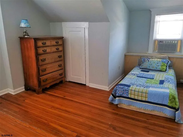 a bedroom with a bed and a dresser