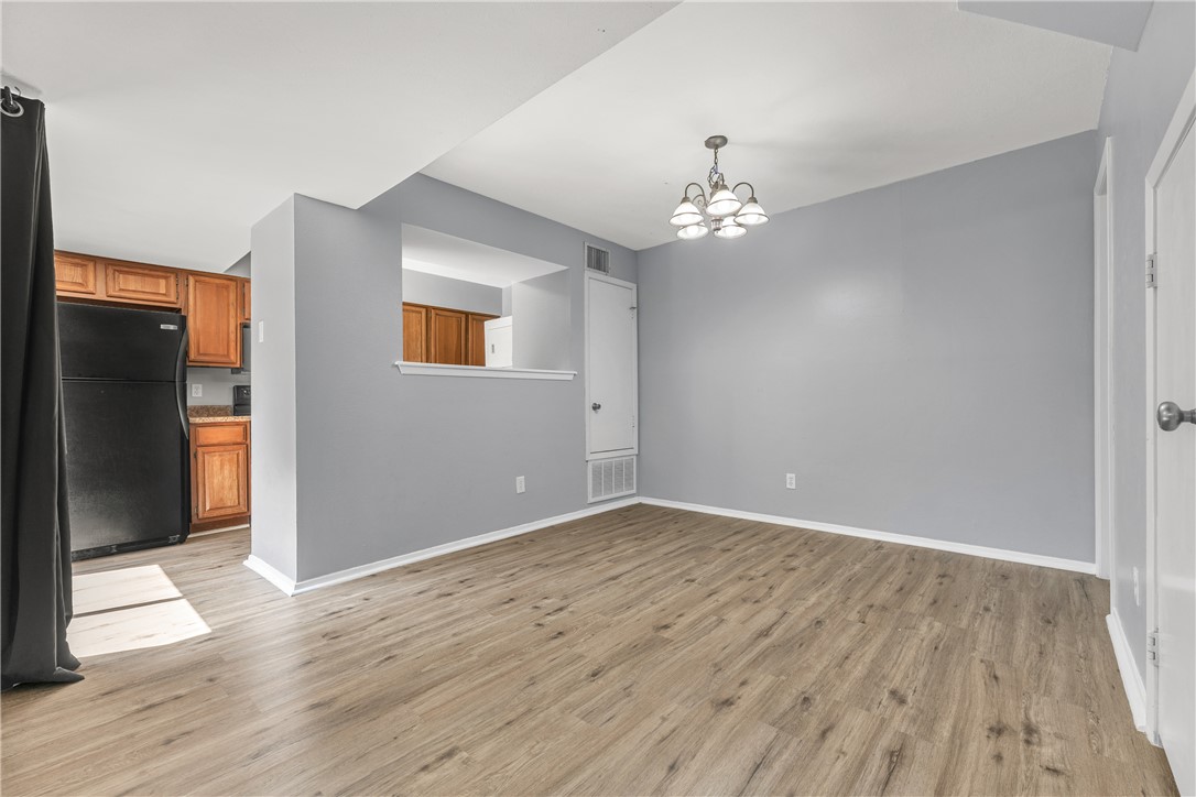 2101 Barak Lane, Unit 17 Bryan, TX 77802 - Photo 6 of 19 wooden floor in an empty room with a window