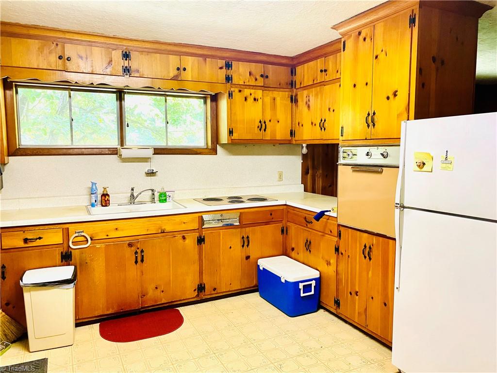 825 Hickory Chapel Road High Point, NC 27260 - Photo 2 of 16 Charming knotty pine cabinetry in cozy kitchen