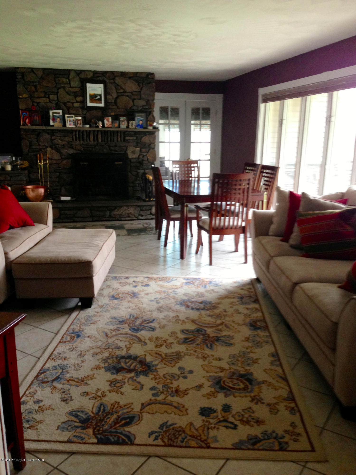20 Green Acres Road Tunkhannock, PA 18657 - Photo 4 of 40 a living room with furniture a fireplace and lots of windows