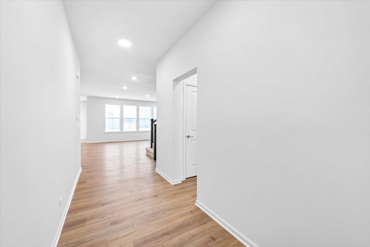 102 Hedgerow Drive Elgin, IL 60124 - Photo 12 of 48 a view of an empty room with wooden floor and a window