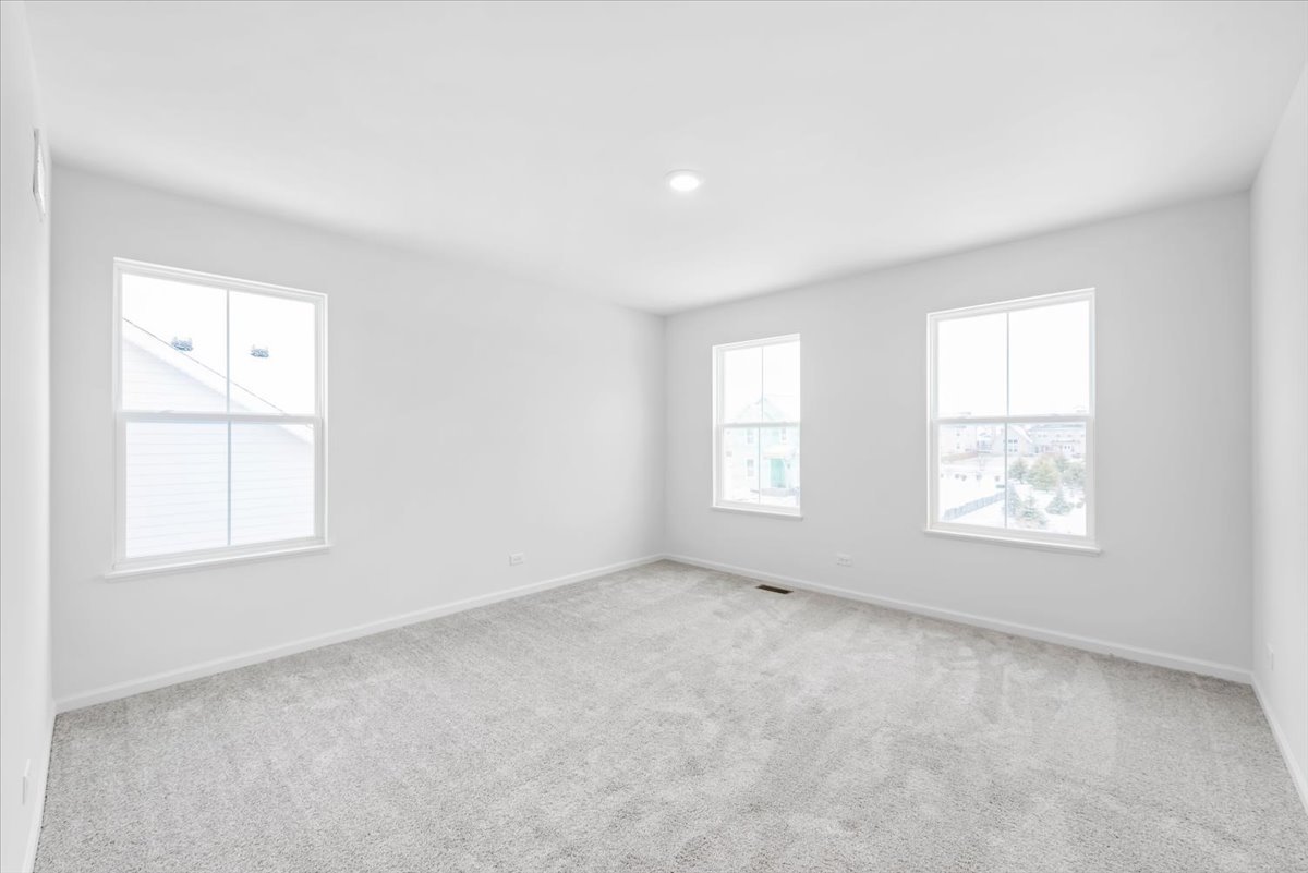 102 Hedgerow Drive Elgin, IL 60124 - Photo 16 of 48 an empty room with windows