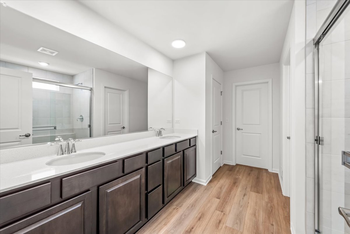 102 Hedgerow Drive Elgin, IL 60124 - Photo 20 of 48 a spacious bathroom with a double vanity sink and mirror