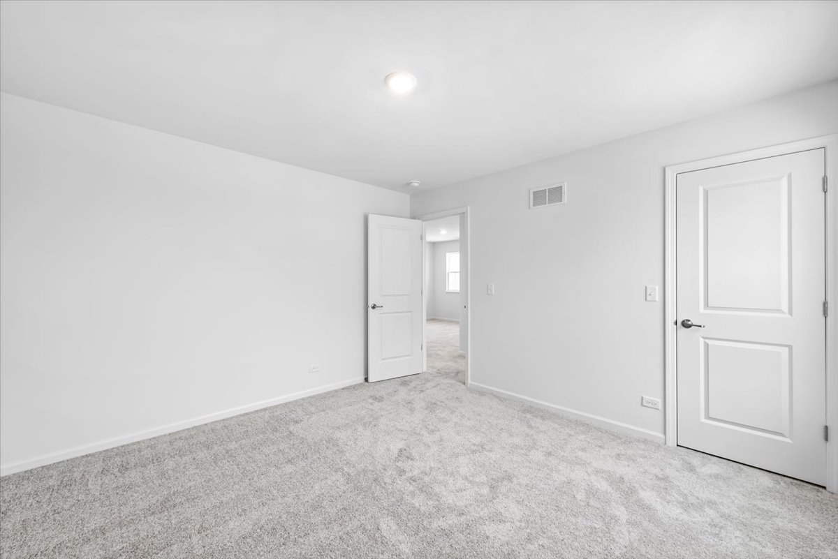 102 Hedgerow Drive Elgin, IL 60124 - Photo 26 of 48 an empty room with an entryway