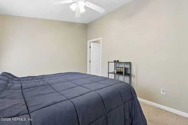 a bedroom with a large bed and a chandelier