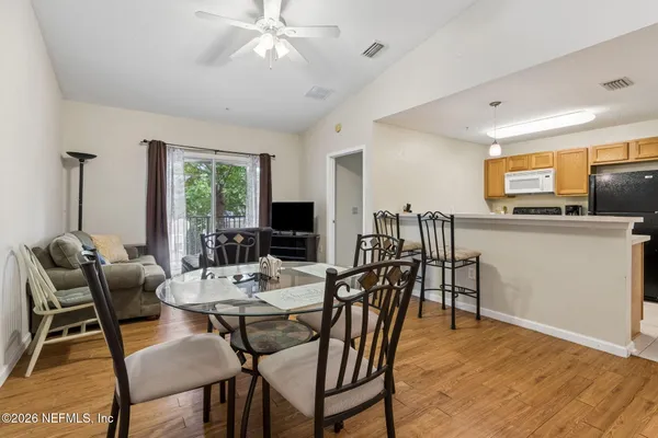 a view of a dining room with furniture window and wooden floor
