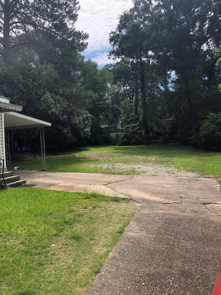 3110 Norris Road Columbus, GA 31907 - Photo 8 of 14 a view of a patio with a table and chairs under an umbrella