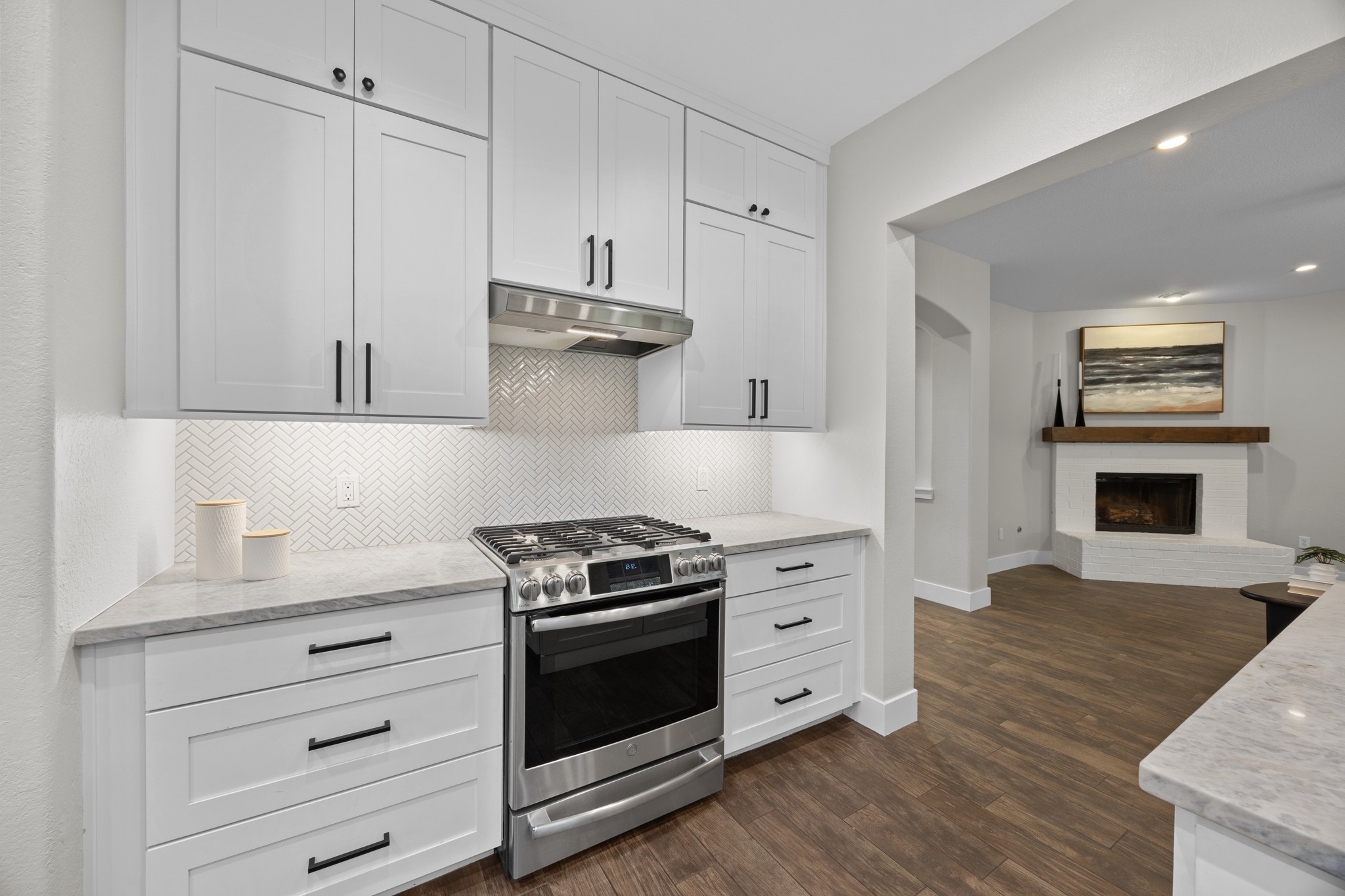 6900 Magenta Lane Austin, TX 78739 - Photo 14 of 40 a kitchen with stainless steel appliances a stove and white cabinets