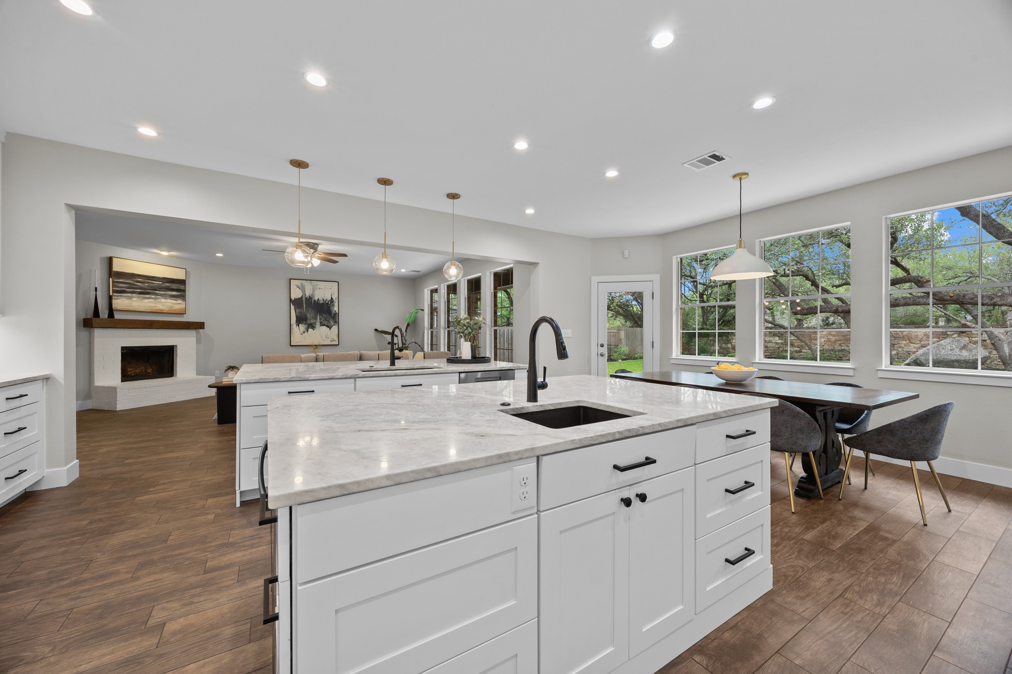 6900 Magenta Lane Austin, TX 78739 - Photo 16 of 40 a kitchen with kitchen island a sink and a stove with wooden floor