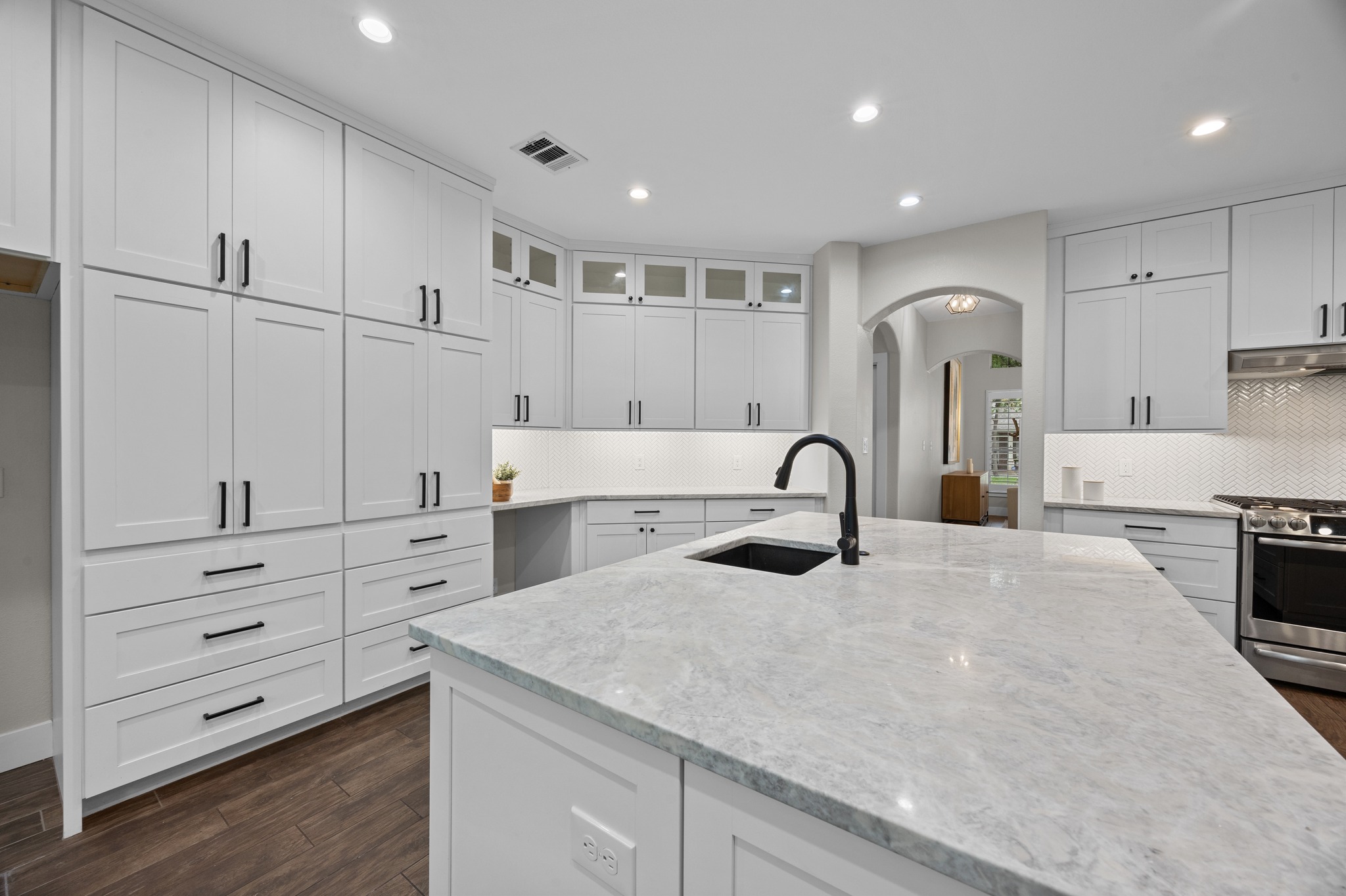 6900 Magenta Lane Austin, TX 78739 - Photo 17 of 40 a kitchen with white cabinets and sink