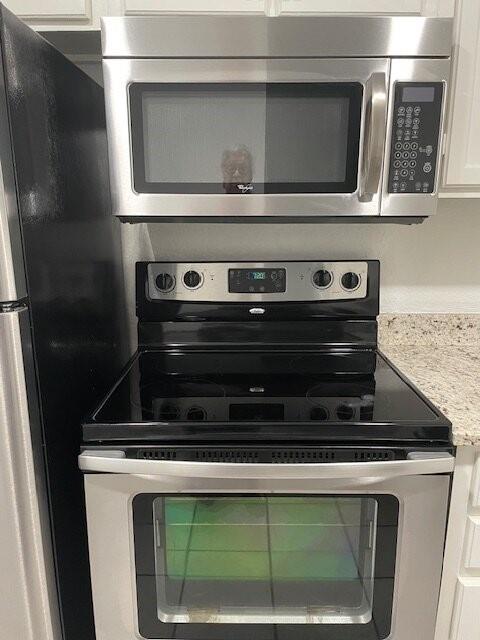 4748 Old Bent Tree Lane, Unit 1905 Dallas, TX 75287 - Photo 18 of 18 a stove top oven sitting inside of a kitchen