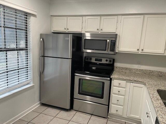 4748 Old Bent Tree Lane, Unit 1905 Dallas, TX 75287 - Photo 2 of 18 a kitchen with cabinets and stainless steel appliances