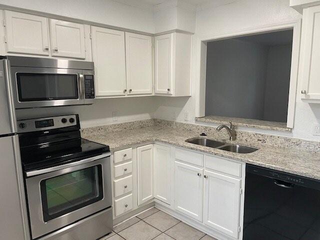 4748 Old Bent Tree Lane, Unit 1905 Dallas, TX 75287 - Photo 3 of 18 a kitchen with granite countertop white cabinets and stainless steel appliances