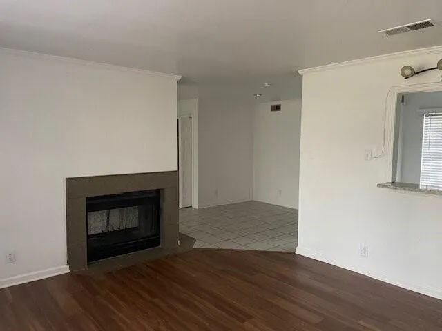 a room with a fireplace and wooden floor