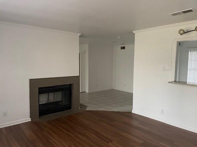 4748 Old Bent Tree Lane, Unit 1905 Dallas, TX 75287 - Photo 4 of 18 a room with a fireplace and wooden floor