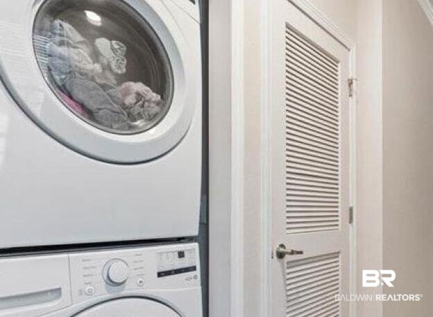 25806 Pollard Road, Unit 203 Daphne, AL 36526 - Photo 14 of 14 Laundry room with stacked washer / dryer and baseboards