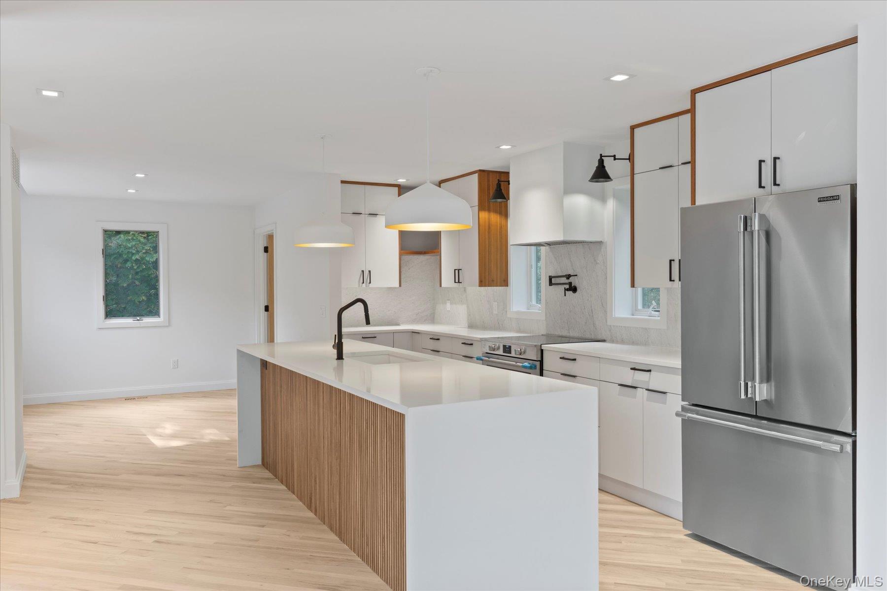 3630 Soundview Avenue Peconic, NY 11958 - Photo 13 of 44 a kitchen with stainless steel appliances granite countertop a refrigerator and a sink