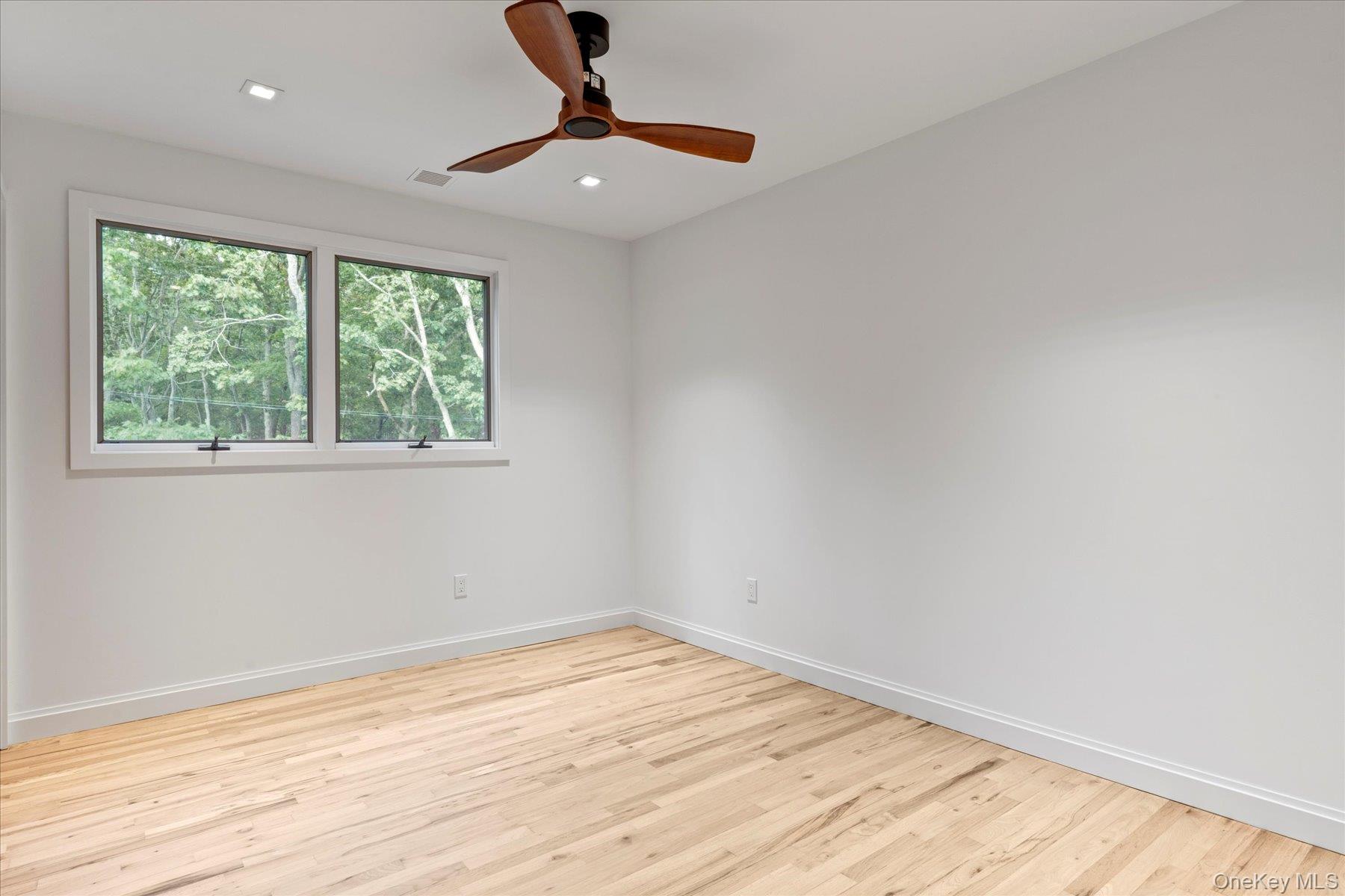 3630 Soundview Avenue Peconic, NY 11958 - Photo 16 of 44 wooden floor in an empty room with a window