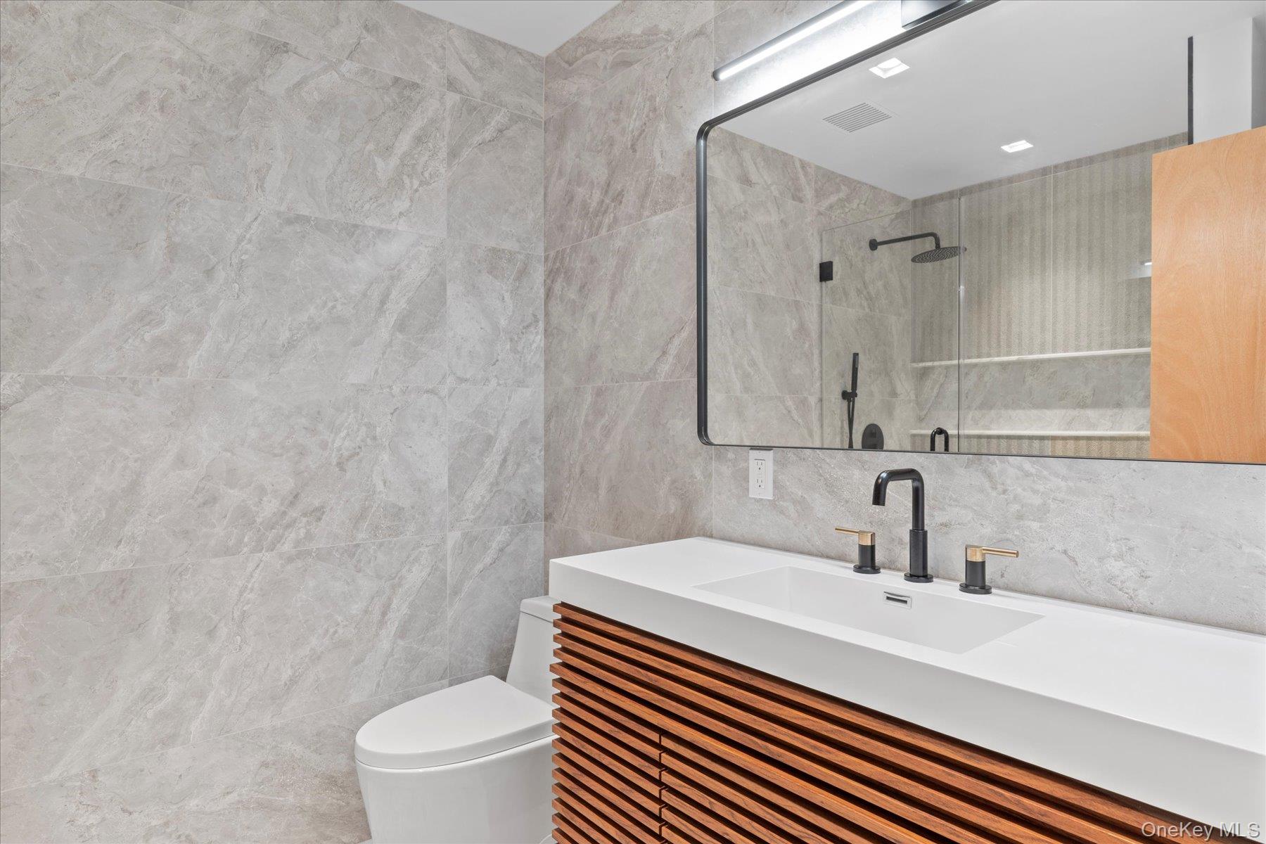 3630 Soundview Avenue Peconic, NY 11958 - Photo 17 of 44 a bathroom with a sink a toilet and shower