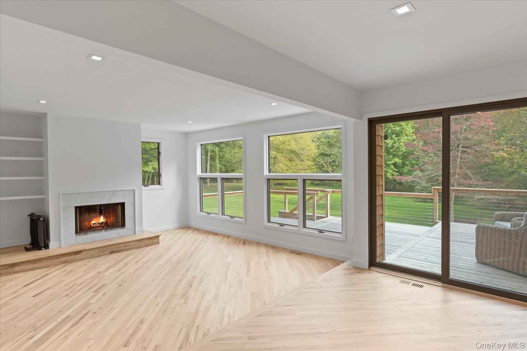 3630 Soundview Avenue Peconic, NY 11958 - Photo 20 of 44 a view of empty room with wooden floor and fireplace