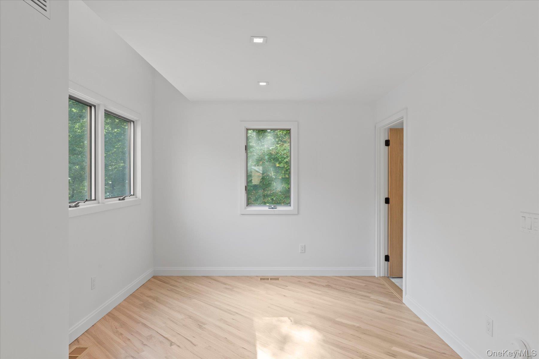 3630 Soundview Avenue Peconic, NY 11958 - Photo 7 of 44 a view of an empty room with wooden floor and a window