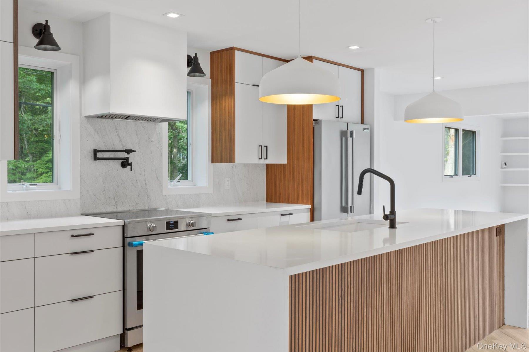 3630 Soundview Avenue Peconic, NY 11958 - Photo 10 of 44 a kitchen with stainless steel appliances a sink a stove and a refrigerator