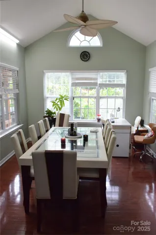 a view of a dining room with furniture a chandelier and wooden floor