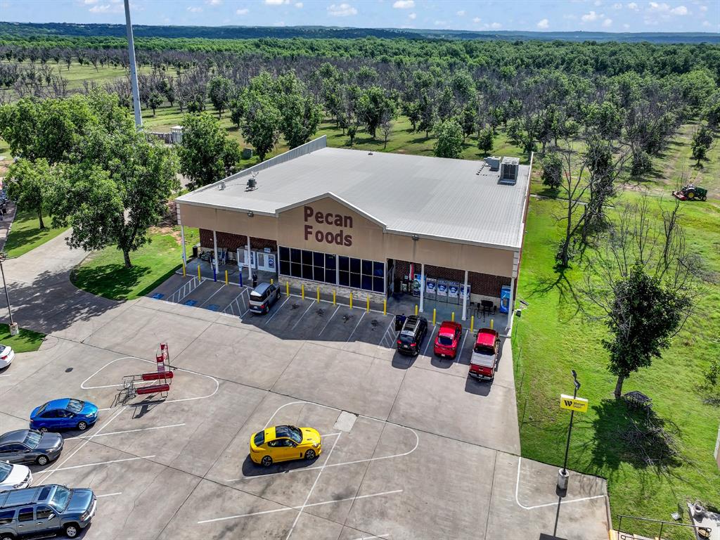 8419 West Landings Road Granbury, TX 76049 - Photo 36 of 39 an aerial view of a house with swimming pool and large trees