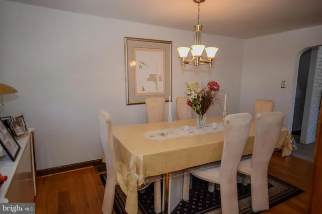 a view of a dining room with furniture and a chandelier