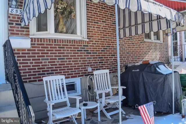 a view of a patio with a table and chairs