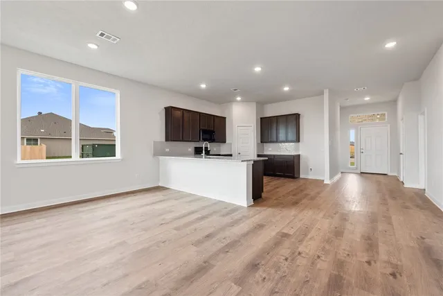 a view of a kitchen with a sink and a stove top oven