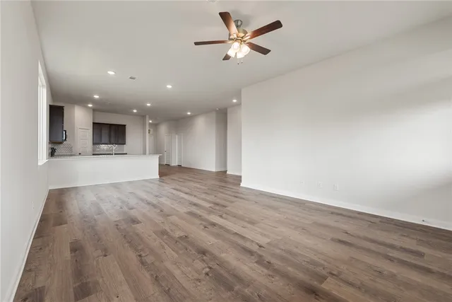 a bathroom with a granite countertop sink a toilet and a mirror