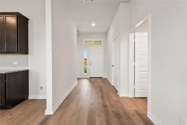 a kitchen with a refrigerator and a stove top oven