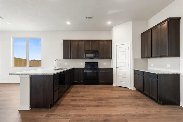 a view of a kitchen with a sink and a refrigerator